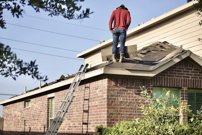 Professional roofer working on a residential roof in Orchard Pond